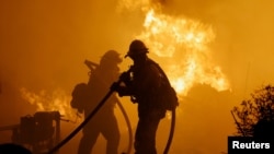 Firefighters work as the Park Fire burns near Chico, California, July 25, 2024.