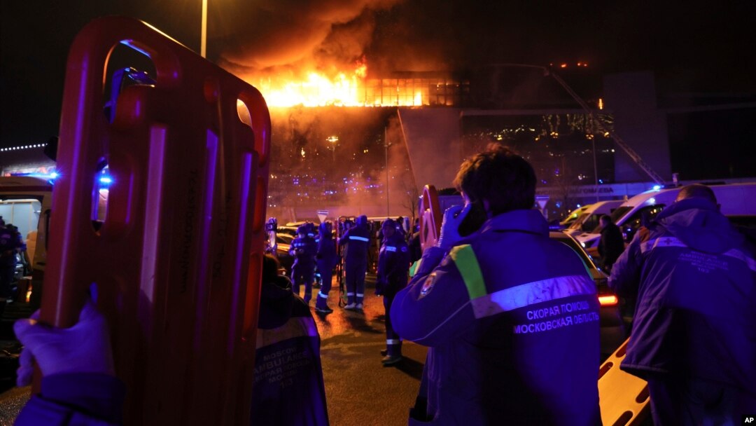 Seorang petugas medis berdiri di dekat ambulans yang diparkir di luar gedung Balai Kota Crocus yang terbakar di tepi barat Moskow, Rusia, Jumat, 22 Maret 2024. (Foto: AP)