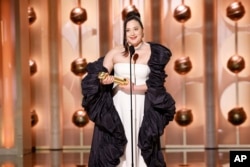 Lily Gladstone accepts the award for best female actor in motion picture - drama for her role in "Killers of the Flower Moon" during the 81st Annual Golden Globe Awards in Beverly Hills, Calif., on Sunday, Jan. 7, 2024. (Sonja Flemming/CBS via AP)
