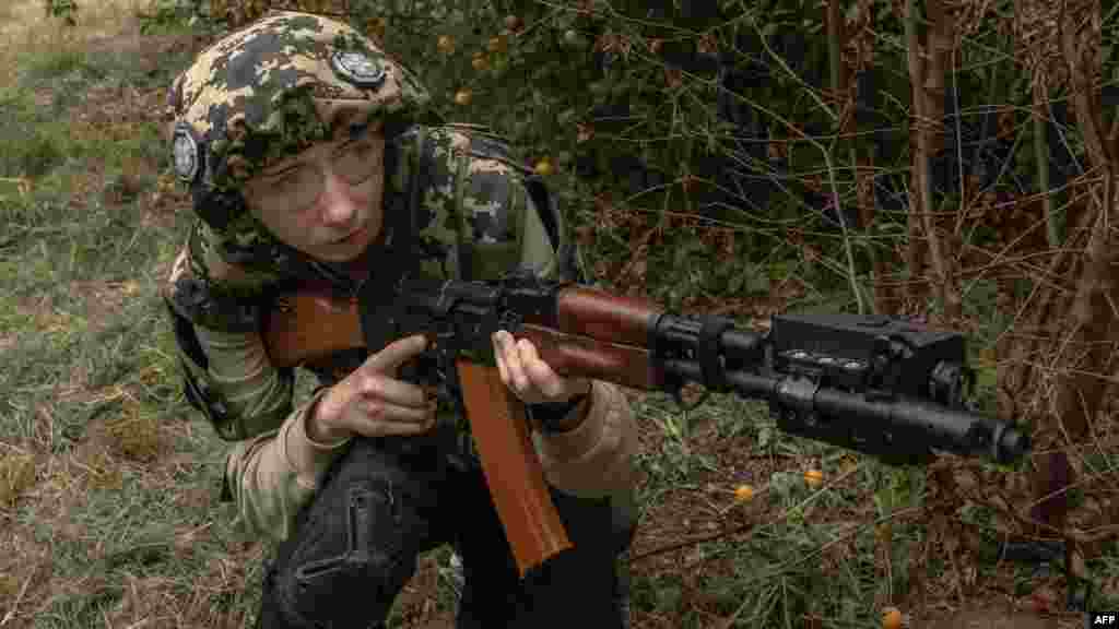 A participant takes part in a trainig during her 5 days of National resistance military training for civilians, in Kyiv, Ukraine, on Aug. 11, 2023