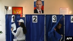 Voters cast their ballots at a polling station in Donetsk, Russian-controlled Ukraine, March 16, 2024.