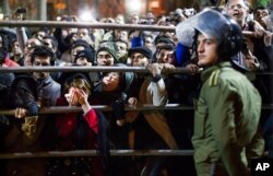 FILE - Iranian women react during a public execution in Tehran, Iran, Jan. 20, 2013. U.N. investigators said on July 5, 2023, that several men have been executed in Iran in connection with the protests that erupted following the death of Mahsa Amini.