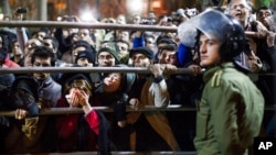 FILE - Iranian women react during a public execution in Tehran, Iran, Jan. 20, 2013. A human rights group has denounced a public hanging in Iran on May 25, 2023, that appeared to have drawn hundreds of onlookers.