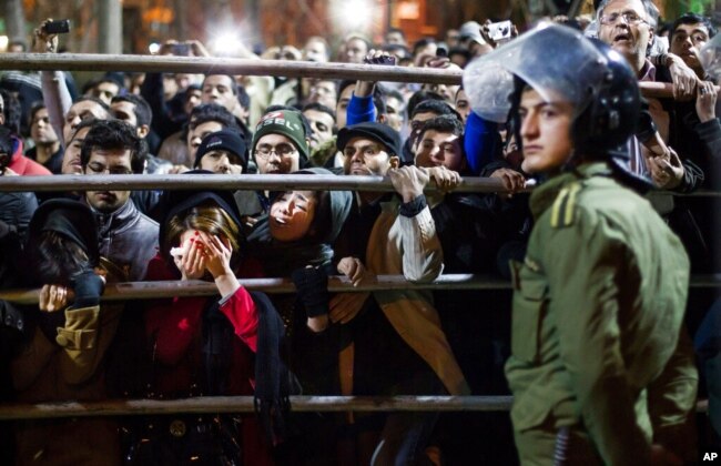 FILE - Iranian women react during a public execution in Tehran, Iran, Jan. 20, 2013. U.N. investigators said on July 5, 2023, that several men have been executed in Iran in connection with the protests that erupted following the death of Mahsa Amini.