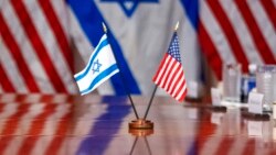 Israeli and U.S. flags are reflected on a conference table where Defense Secretary Lloyd Austin met with Israeli Defense Minister Yoav Gallant, at the Pentagon, March 26, 2024, in Washington.