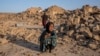 An Afghan girl cries in front of her house that was destroyed by the earthquake in Zindajan district in the Herat province of western Afghanistan, Oct. 11, 2023. 