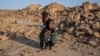 An Afghan girl cries in front of her house, which was destroyed by the earthquake in Zindajan district in the Herat province of western Afghanistan, Oct. 11, 2023. 