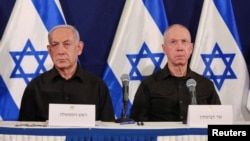 FILE - Israeli Prime Minister Benjamin Netanyahu and Defense Minister Yoav Gallant attend a press conference at Kirya military base in Tel Aviv, Oct. 28, 2023.