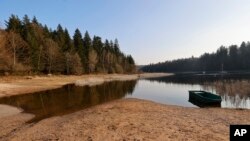 FILE - A boat floats on Pierre-Percee Lake in France, March 1, 2023. France recorded 32 days without rain this winter – the longest winter drought since record-keeping began in 1959.