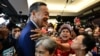 Pheu Thai Party's Srettha Thavisin, center, is hugged by supporters at the party headquarters after the parliament's prime ministerial vote in Bangkok on Aug. 22, 2023. 