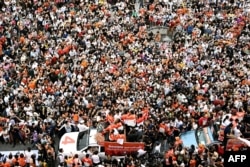 Move Forward Party leader and prime ministerial candidate Pita Limjaroenrat, bottom center in white shirt, takes part in a victory parade in Bangkok on May 15, 2023.