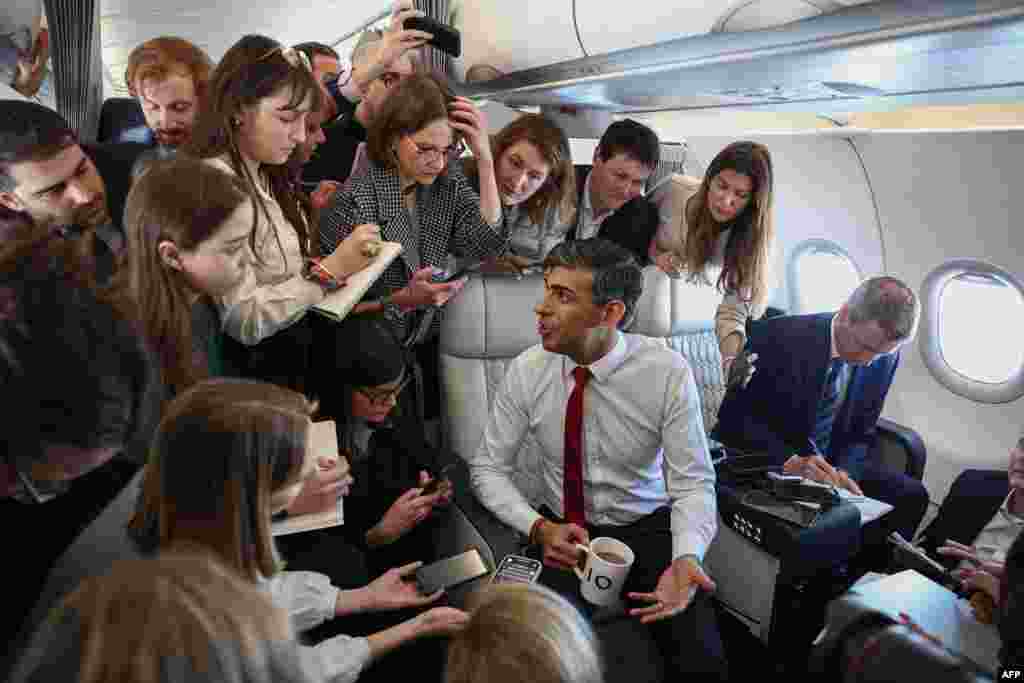 Britain&#39;s Prime Minister Rishi Sunak speaks to reporters on board a plane on the way to Warsaw Chopin airport in Warsaw, Poland.