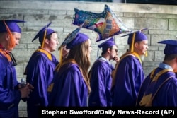 FILE - James Madison University students walk to commencement in Harrisonburg, Virginia, May 5, 2017. The university is one of 13 across the United States that will focus on free speech in the coming year. (Stephen Swofford/Daily News-Record Via AP)