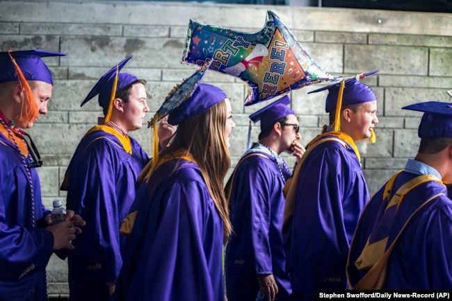 FILE - James Madison University students walk to commencement in Harrisonburg, Virginia, May 5, 2017. The university is one of 13 across the United States that will focus on free speech in the coming year. (Stephen Swofford/Daily News-Record Via AP)