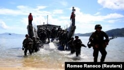 (FILE) Filipino soldiers disembark from a landing craft as part of the Philippines-U.S. Balikatan.