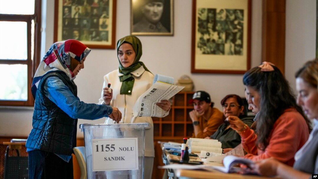 A woman votes at a polling station in Istanbul, March 31, 2024.