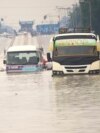 Public minibuses are caught in the flooded streets of Dar es Salaam, Tanzania, April 25, 2024. Flooding in Tanzania caused by weeks of heavy rain has killed 155 people and affected more than 200,000 others, the prime minister said Thursday.