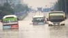 Public minibuses are caught in the flooded streets of Dar es Salaam, Tanzania, April 25, 2024. Flooding in Tanzania caused by weeks of heavy rain has killed 155 people and affected more than 200,000 others, the prime minister said Thursday.