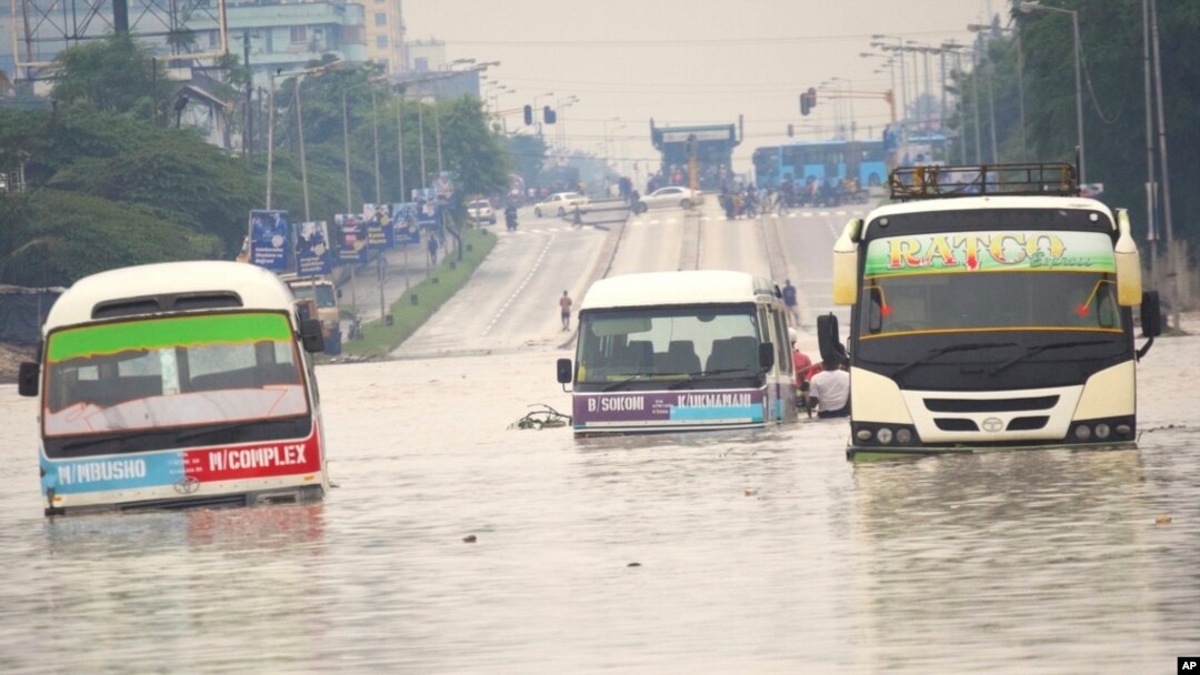 Public minibuses are caught in the flooded streets of Dar es Salaam, Tanzania, April 25, 2024. Flooding in Tanzania caused by weeks of heavy rain has killed 155 people and affected more than 200,000 others, the prime minister said Thursday.