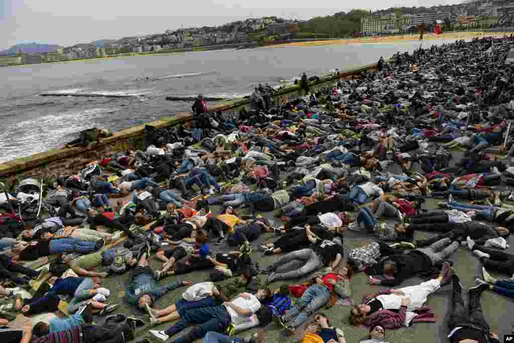 Demonstrators lie on the ground to protest against Israeli attacks on Gaza, in San Sebastian, northern Spain.