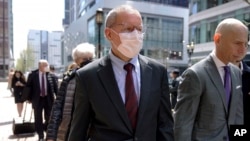 Charles Lieber, center, departs federal court in Boston, April 26, 2023. Lieber, a former Harvard professor convicted of lying to federal investigators about ties to a Chinese-run science recruitment program was sentenced Wednesday. 