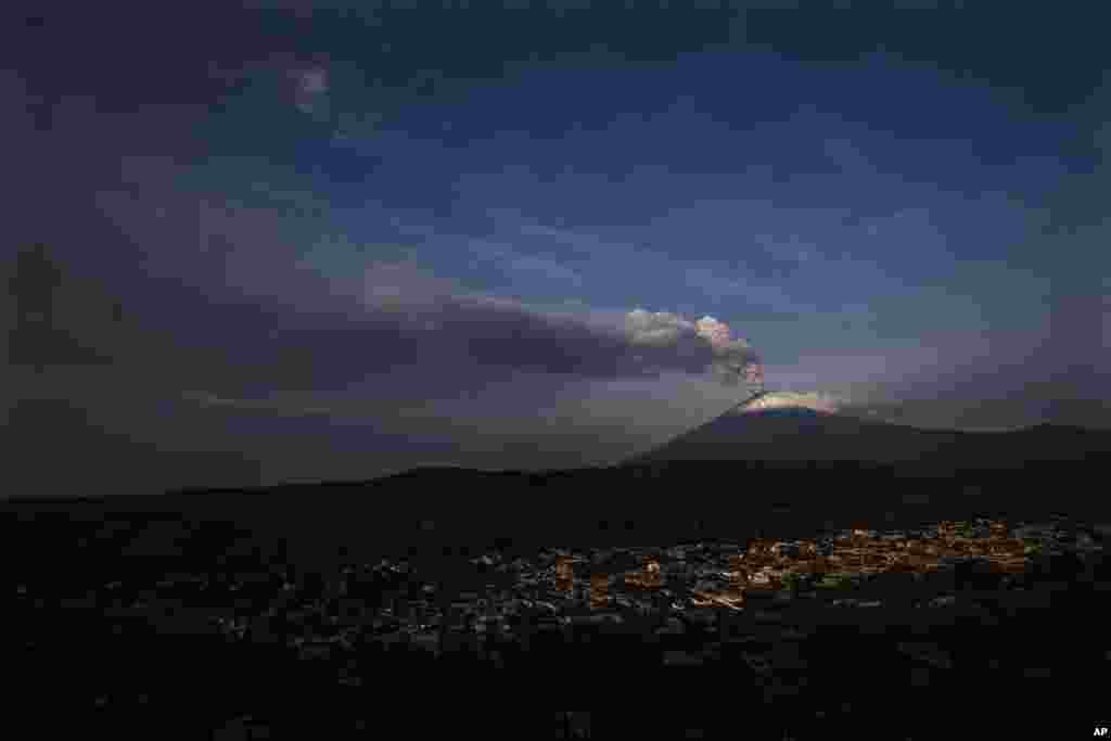 The Popocatepetl volcano spews ash and steam, seen from Santiago Xalitzintla, Mexico.