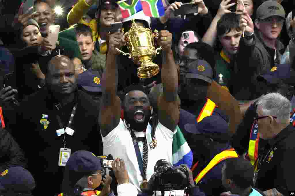 South Africa&#39;s Siya Kolisi holds the Webb Ellis trophy as fans welcome South Africa&#39; Springbok team during their arrival at O.R Tambo&#39;s international airport in Johannesburg, South Africa, Tuesday October 31, 2023, after the Rugby World Cup.