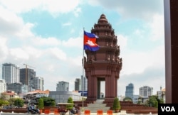 Commuters drive pass the Independent Monument in Phnom Penh, on Monday, March 20, 2023.