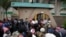 Travelers are seen in a queue outside the passport offices in Harare, Zimbabwe, Dec. 20, 2023. 