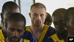 American Tyler Thompson Jr., center, sits in court in Kinshasa, Congo, June 7, 2024.