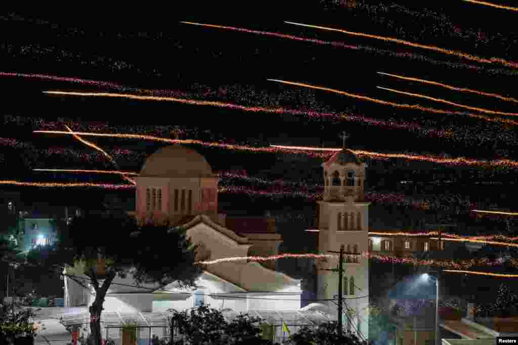Рачно изработени ракети летаат над црквата Свети Марко за време на Велигденски прослави во селото Вронтадос, на островот Хиос, Грција, 4 мај 2024 година.