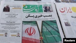 A newspaper with the flags of Iran and Saudi Arabia on its front page is seen in Tehran, Iran, March 11, 2023. (Majid Asgaripour/West Asia News Agency via Reuters).