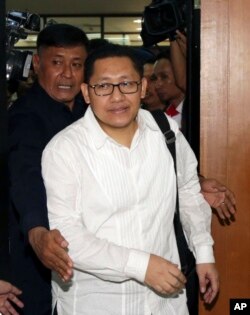 Polisi Indonesia mengawal Anas Urbaningrum (tengah), mantan ketua umum Partai Demokrat di pengadilan antikorupsi selama sidang putusan di Jakarta, 24 September 2014. (AP/Achmad Ibrahim)