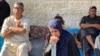 FILE - Mourners react next to the bodies of Palestinians (not pictured) killed in an Israeli strike, in Deir al-Balah in central Gaza Strip, May 24, 2024.