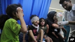 Palestinian children wounded in Israeli strikes are brought to Shifa Hospital in Gaza City on Oct. 11, 2023.
