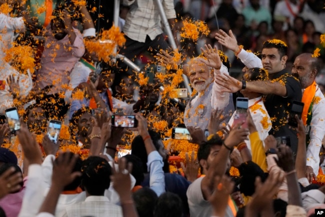 FILE - Indian Prime Minister Narendra Modi greets supporters as he arrives for an election campaign rally of his Bharatiya Janata Party (BJP) in Hyderabad, India, Tuesday, Nov. 7, 2023. (AP Photo/Mahesh Kumar A. File)