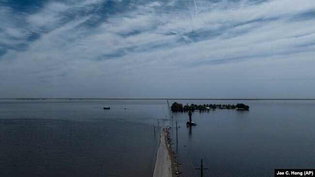 Farmland in the Tulare Lake Basin is submerged in water in Corcoran, Calif., Thursday, April 20, 2023, after more than a dozen atmospheric rivers dumped record-setting rain and snowfall.