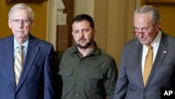 Ukrainian President Volodymyr Zelenskyy, center, walks with Senate Minority Leader Mitch McConnell, left, and Senate Majority Leader Chuck Schumer on Capitol Hill in Washington, Sept. 21, 2023.