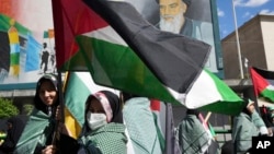 Iranian demonstrators hold Palestinian flags in their rally to mark Jerusalem Day, an annual show of support for the Palestinians, in Tehran, Iran, April 14, 2023. 