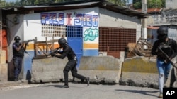 National Police patrol the area near the empty National Penitentiary after a small fire inside the jail in downtown Port-au-Prince, Haiti, March 14, 2024. It's the same prison that armed gangs stormed March 2 and hundreds of inmates escaped.