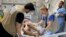 Monica Johnston, a burn and wound care nurse from the U.S. city of Portland, Oregon, with the Palestinian American Medical Association, monitors a patient who sustained major burns on May 8, 2024, in Khan Younis, Gaza.