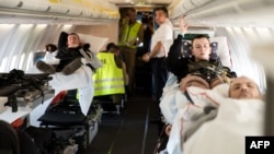 Wounded Ukrainian soldiers including Mykola Fedirko (R) are transported in a medical evacuation (Medevac) airplane, in Rzeszow, Poland on March 22, 2023.