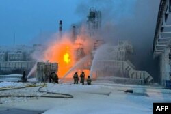 This handout photograph published on the official Telegram account of the governor of the Leningrad region, Jan. 21, 2024, shows rescuers working to extinguish a fire at a natural gas terminal of Ust-Luga. (AFP photo / Telegram account @drozdenko_au_lo)