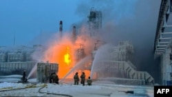 This handout photograph published on the official Telegram account of the governor of the Leningrad region, Jan. 21, 2024, shows firefighters working to extinguish a blaze at a natural gas terminal at Ust-Luga Russian Baltic Sea port. (AFP photo/Telegram account @drozdenko_au_lo)