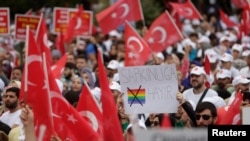 FILE - A demonstrator holds a placard that reads "No to perversion" during an anti-LGBT rally organized by pro-Islamic NGOs in Istanbul, Sept. 18, 2022.