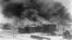 FILE - Smoke billows over Tulsa, Oklahoma, in this 1921 image provided by the Library of Congress.