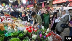 People shop at a market in Tehran on March 14, 2023, ahead of the Nowruz New Year festival. Millions of people across the Middle East, Asia and Eastern Europe celebrate Nowruz new year festival, which marks the start of spring.