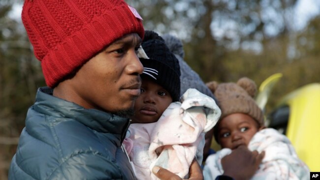 Haitian migrant Gerson Solay and his family cross into Canada at the unofficial Roxham Road border crossing north of Champlain, New York, March 24, 2023. The U.S. and Canada have reached a deal aimed at stopping asylum-seekers from crossing the border via unofficial crossings.