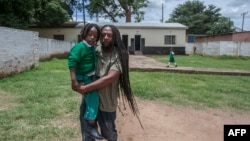 FILE - Ezaius Mkandawire, a Malawian Rasta picks up his son Uhuru from private school in Lilongwe, Jan. 30, 2020.