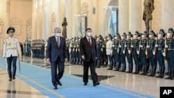 FILE - Chinese President Xi Jinping, right, and Kazakhstan's President Kassym-Jomart Tokayev review an honor guard at the Ak Orda Presidential Palace in Nur-Sultan, Kazakhstan, Sept. 14, 2022. (Xinhua via AP)